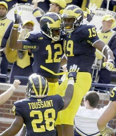 Fitzgerald Toussaint (28), Devin Gardner (12), and Devin Funchess (19)