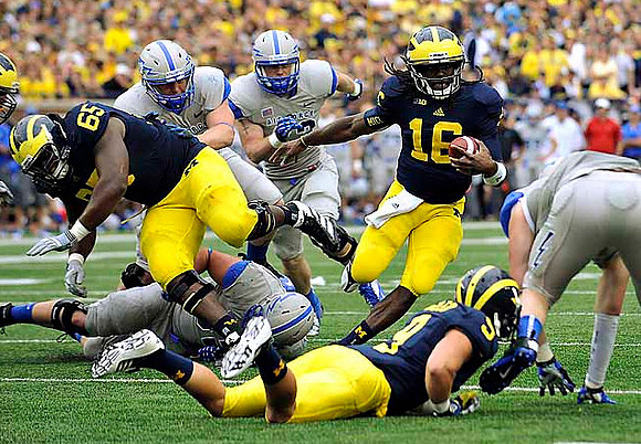 Patrick Omameh (65), Denard Robinson (16), and Drew Dileo (9)