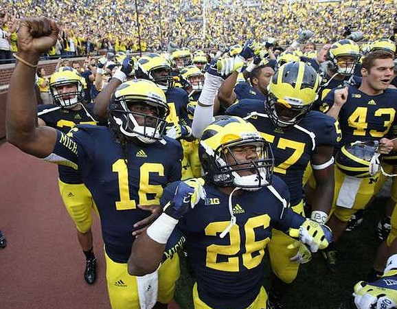 Denard Robinson (16), Dennis Norfleet (26), Frank Clark (57), and Will Hagerup (43)
