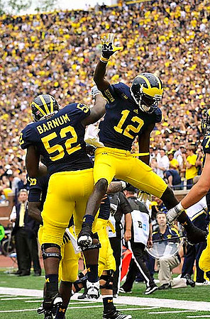 Ricky Barnum (52) and Devin Gardner (12)
