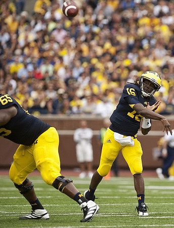 Patrick Omameh (65) and Denard Robinson (16)