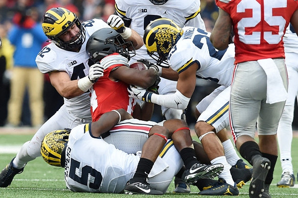 Ben Gedeon (42), Jabrill Peppers (5), and Tyree Kinnel (23)
