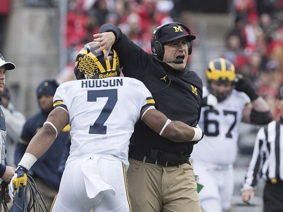 Khaleke Hudson (7), Jim Harbaugh, and Kyle Kalis (67)