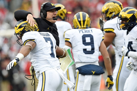 Khaleke Hudson (7), Jim Harbaugh, and Grant Perry (9)