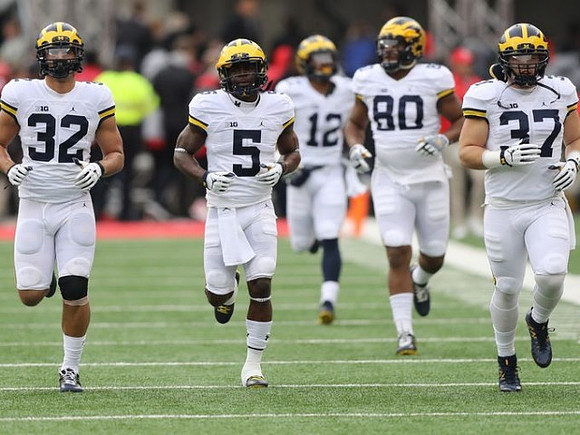 Ty Isaac (32), Jabrill Peppers (5), Chris Evans (12), Khalid Hill (80), and Bobby Henderson (37)