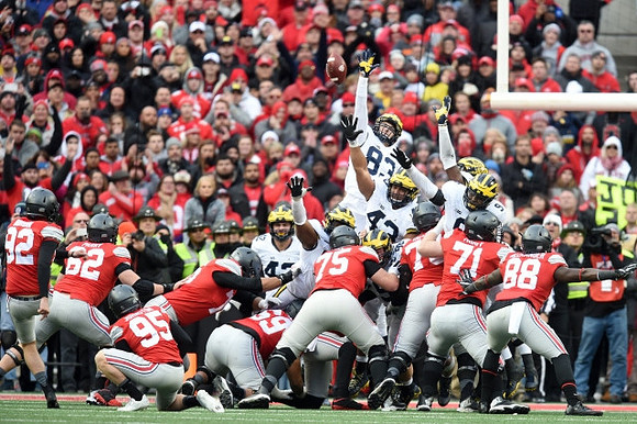 Ben Gedeon (42), Chris Wormley (43), Zach Gentry (83), and Mike McCray (9)