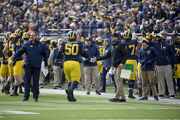 Tim Drevno, Michael Onwenu (50), and Jim Harbaugh