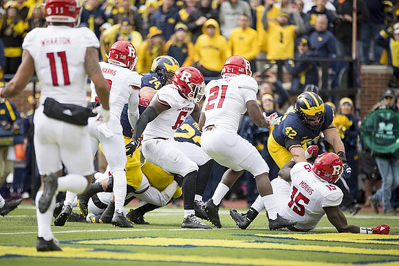 Ben Bredeson (74), Karan Higdon (22), and Ben Mason (42)