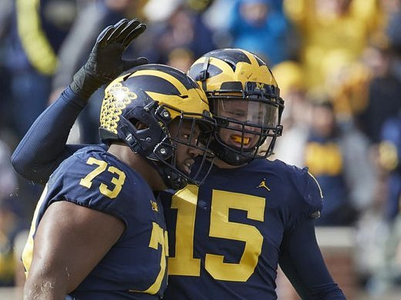 Maurice Hurst (73) and Chase Winovich (15)