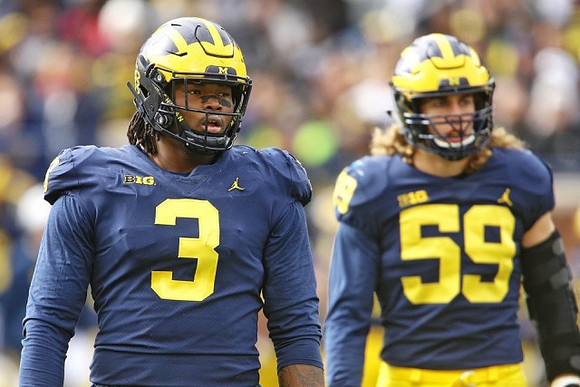 Rashan Gary (3) and Noah Furbush (59)