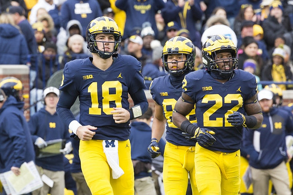 Brandon Peters (18), Grant Perry (88), and Karan Higdon (22)