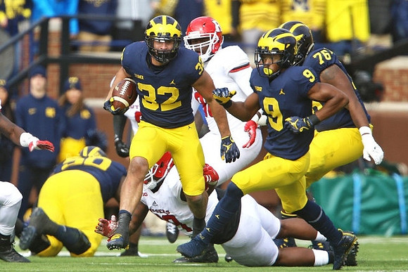 Michael Onwenu (50), Karan Higdon (22), Donovan Peoples-Jones (9), and Juwann Bushell-Beatty (76)