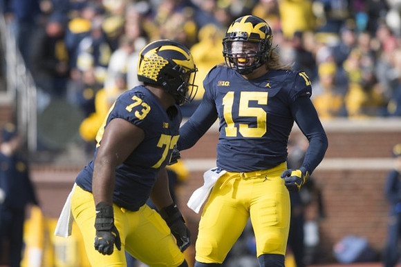 Maurice Hurst (73) and Chase Winovich (15)