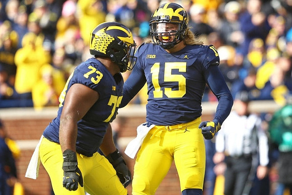 Maurice Hurst (73) and Chase Winovich (15)