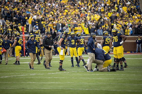 Jim Harbaugh, Patrick Kugler (57), Donovan Peoples-Jones (9), Ty Isaac (32), Mason Cole (52), and Juwann Bushell-Beatty (76)