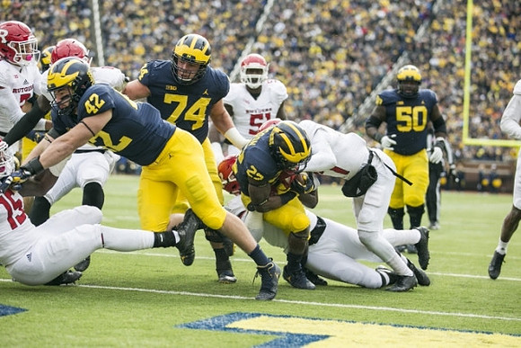 Ben Mason (42), Ben Bredeson (74), Karan Higdon (22), and Michael Onwenu (50)