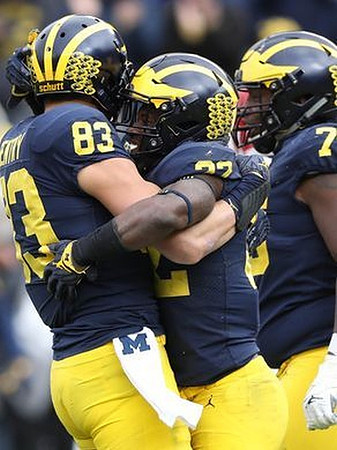 Zach Gentry (83), Karan Higdon (22), and Juwann Bushell-Beatty (76)