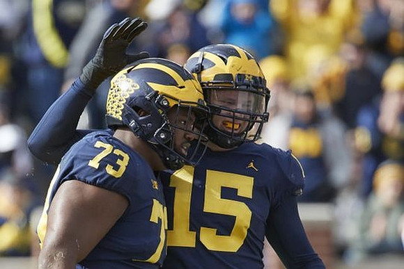 Maurice Hurst (73) and Chase Winovich (15)
