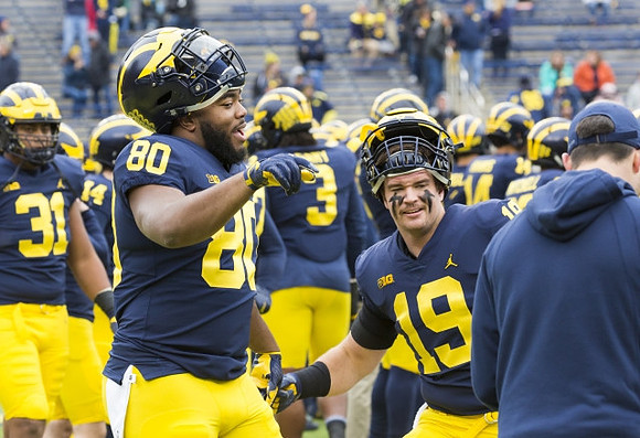 Khalid Hill (80) and Henry Poggi (19)