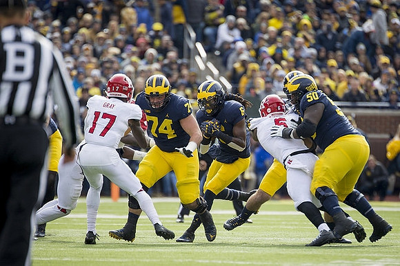 Ben Bredeson (74), Kareem Walker (6), and Michael Onwenu (50)