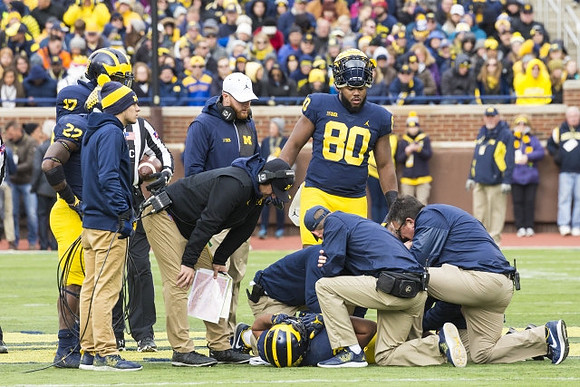 Tyrone Wheatley Jr. (17), Karan Higdon (22), Jay Harbaugh, Jim Harbaugh, Khalid Hill (80), and Ty Isaac (32)