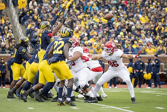 Devin Bush (10), Chase Winovich (15), and David Long (22)