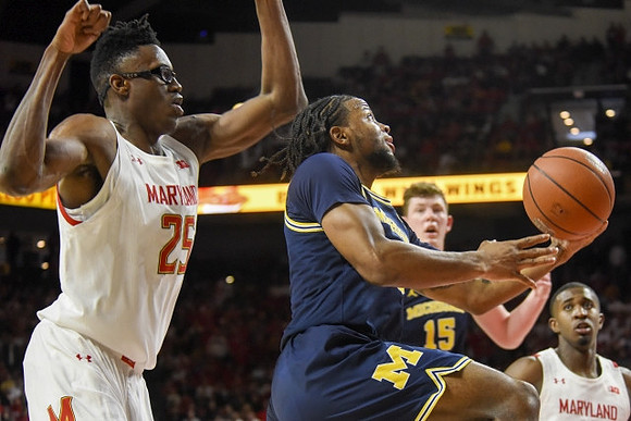 Zavier Simpson (3) and Jon Teske (15)