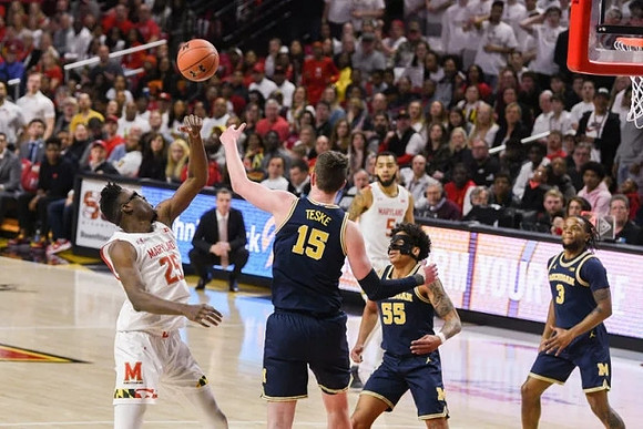 Jon Teske (15), Eli Brooks (55), and Zavier Simpson (3)
