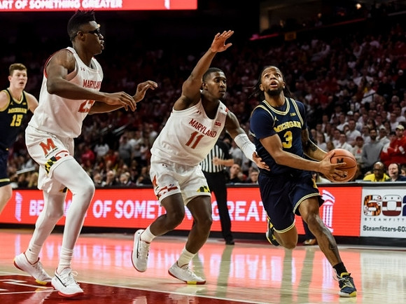 Zavier Simpson (3) and Jon Teske (15)