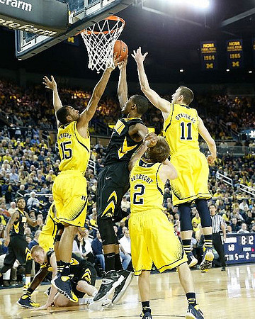 Jon Horford (15), Spike Albrecht (2), and Nik Stauskas (11)