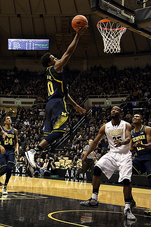 Aubrey Dawkins (24), Derrick Walton Jr. (10), and Zak Irvin (21)