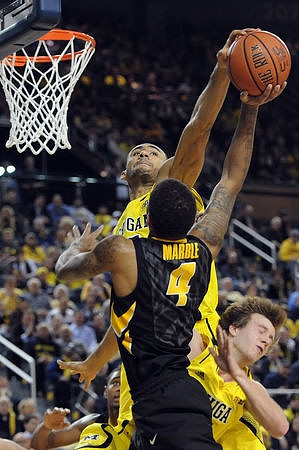 Jon Horford (15) and Spike Albrecht (2)