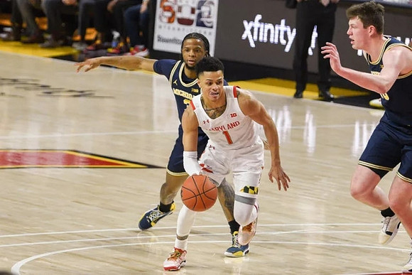 Zavier Simpson (3) and Jon Teske (15)