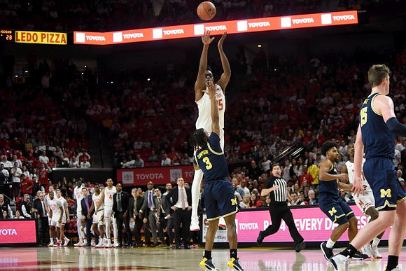 Zavier Simpson (3) and Jon Teske (15)