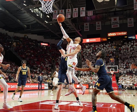 Eli Brooks (55), Juwan Howard, Jon Teske (15), and Zavier Simpson (3)