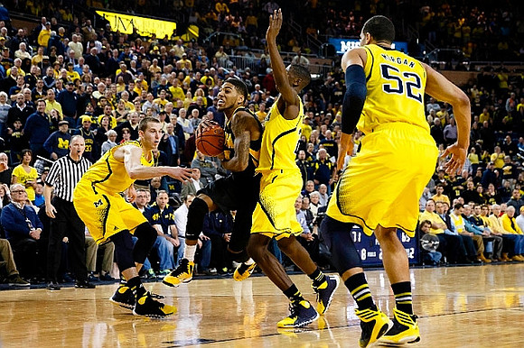 Spike Albrecht (2), Caris LeVert (23), and Jordan Morgan (52)