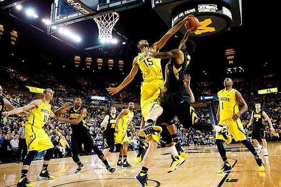 Nik Stauskas (11), Zak Irvin (21), Jon Horford (15), and Glenn Robinson III (1)
