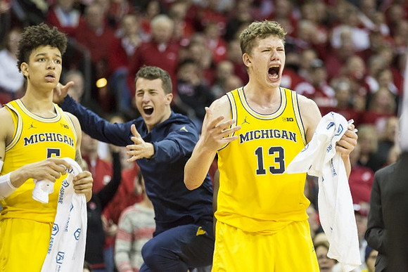 D.J. Wilson (5), Andrew Dakich (11) , and Moritz Wagner (13)