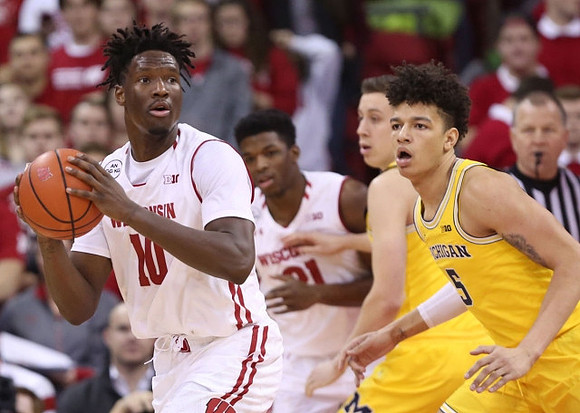 Duncan Robinson (22) and D.J. Wilson (5)