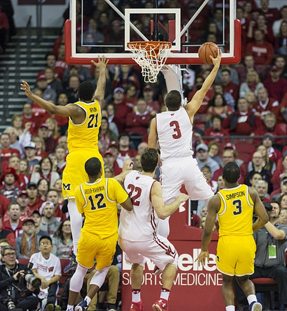 Zak Irvin (21), Muhammad-Ali Abdur-Rahkman (12), and Xavier Simpson (3)