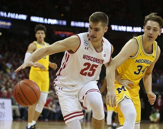 D.J. Wilson (5) and Mark Donnal (34)