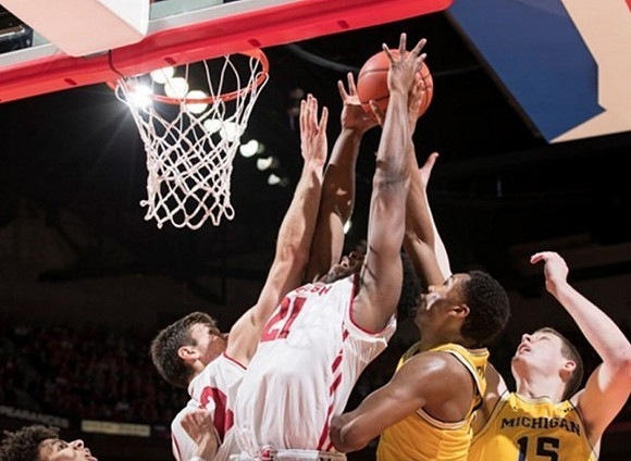 D.J. Wilson (5), Zak Irvin (21), and Jon Teske (15)