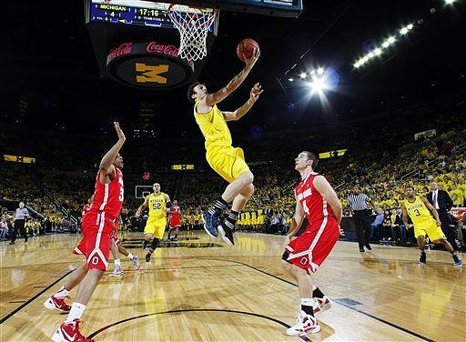 Zack Novak (0), Jordan Morgan (52), and Trey Burke (3)