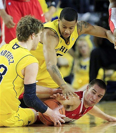 Evan Smotrycz (23) and Trey Burke (3)