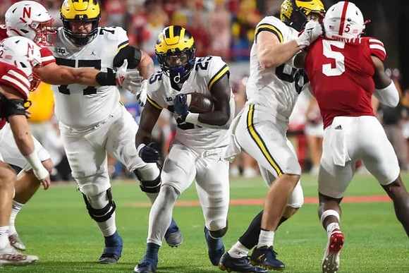 Trevor Keegan (77) and Hassan Haskins (25)