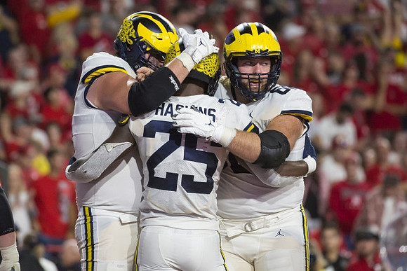 Hassan Haskins (25) and Andrew Vastardis (68)