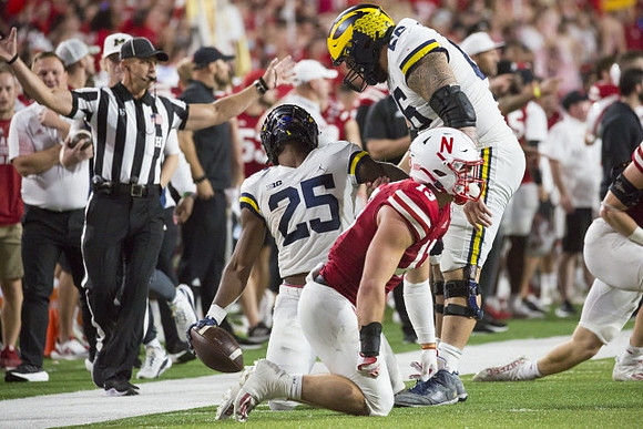 Hassan Haskins (25) and Chuck Filiaga (66)