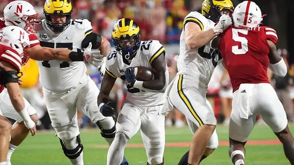 Trevor Keegan (77) and Hassan Haskins (25)
