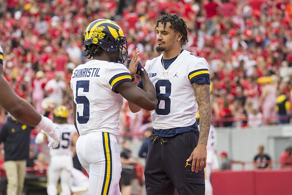 Mike Sainristil (5) and Ronnie Bell (8)