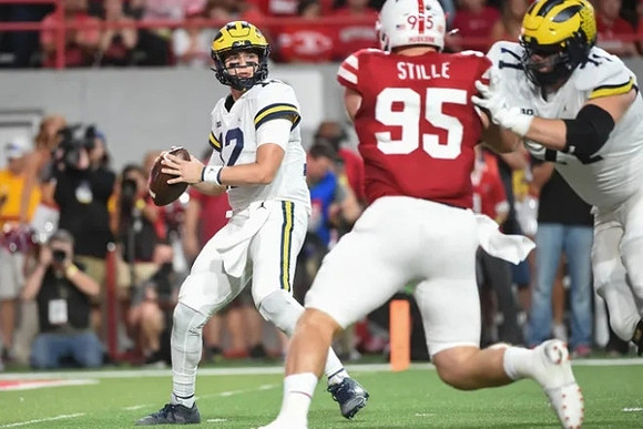 Cade McNamara (12) and Andrew Stueber (71)